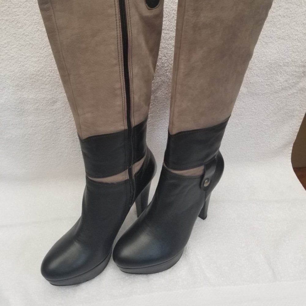 New and unworn all leather tall heeled boot .
